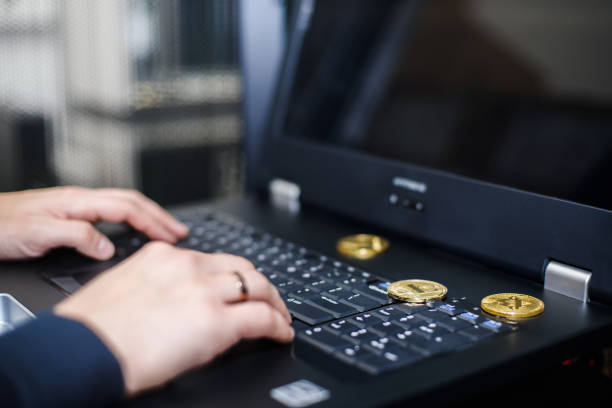 Business concept: cryptocurrency fever. IT specialist is working on laptop, operations cryptocurrency. Bitcoin, litecoin ethereum on laptop, golden coins. Drohobych, Ukraine - January 17, 2018: Business concept: cryptocurrency fever. Bitcoin, litecoin ethereum on PC, golden coins, operations cryptocurrency With Ethereum stock pictures, royalty-free photos & images