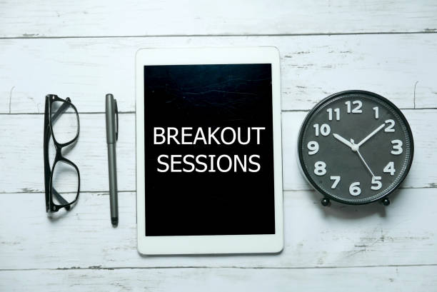 Business concept. Top view of glasses,pen,clock and tablet written with Breakout Sessions on white wooden background. Business concept. Top view of glasses,pen,clock and tablet written with Breakout Sessions on white wooden background. escaping stock pictures, royalty-free photos & images