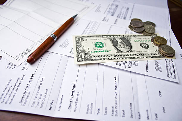 Business forms on table with money on them  stock photo