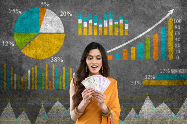 Business graph concept Woman holding indian currency with global business growth Infographic drawn on blackboard asian stock market stock pictures, royalty-free photos & images