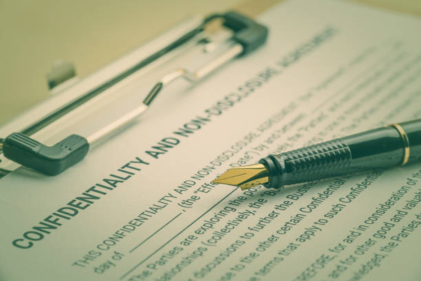 Business legal document concept : Fountain pen on a confidentiality and non disclosure agreement form. Confidentiality agreement is a legal contract between 2 parties that outlines confidential issues stock photo