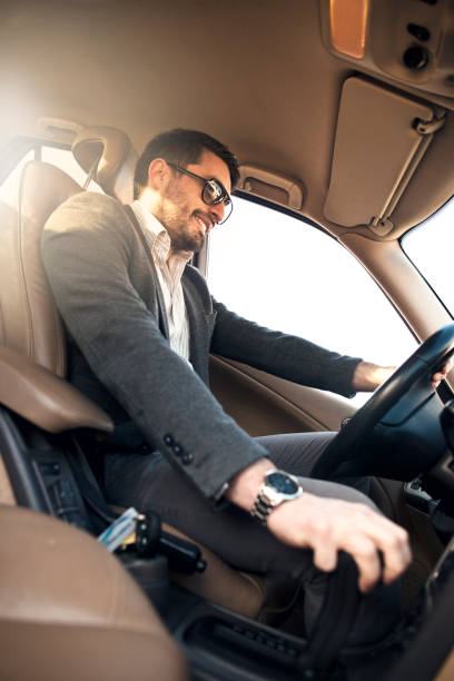 Business Man Driving the Car Portrait of man in his car man driving suit stock pictures, royalty-free photos & images