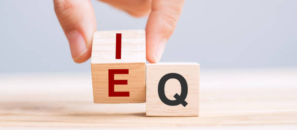 Business man hand change wooden cube block from IQ to EQ, balance between intelligence quotient and emotional intelligence concepts stock photo