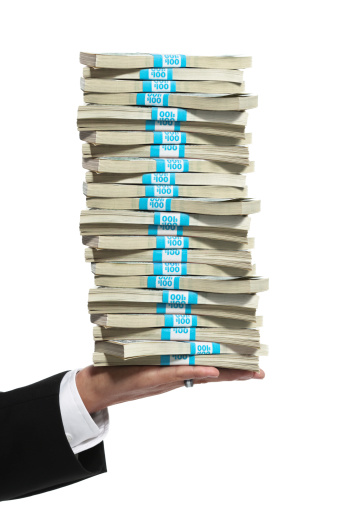 Business Man Hand Holding A Tall Stack Of Money Stock Photo - Download Image Now - iStock