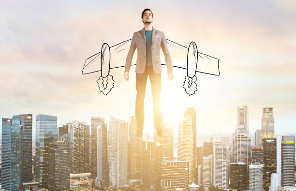 Business man hover over city skyline Business Advantage. Businessman with sketch wings hovering over down town on sunset. hovering stock pictures, royalty-free photos & images