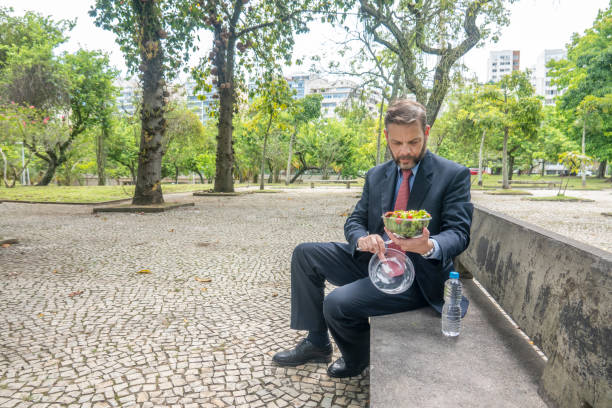 Business man takes a lunch break in a park stock photo