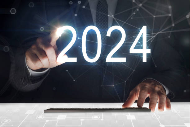 Business man touching screen with "2024" writing stock photo
