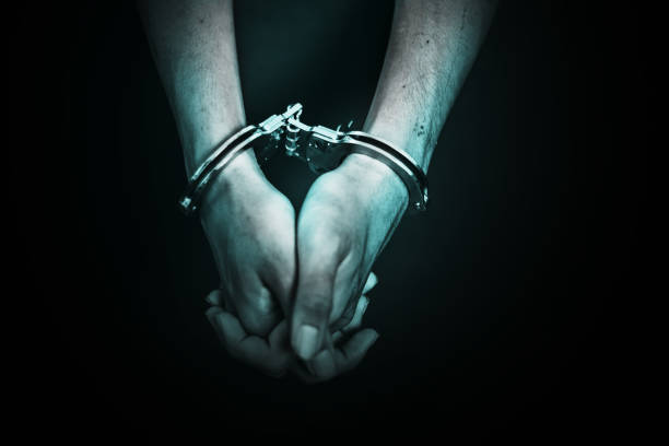 Business Man's hand in handcuff, crime arrested concept stock photo