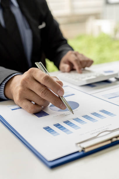 Business men are looking at the company's financial documents to analyze problems and find solutions before bringing the information to a meeting with a partner. Financial concept. stock photo