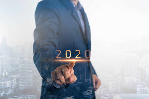 Business new year concept. Businessman touching year 2020.  Indicating the readiness in business plan next year stock photo