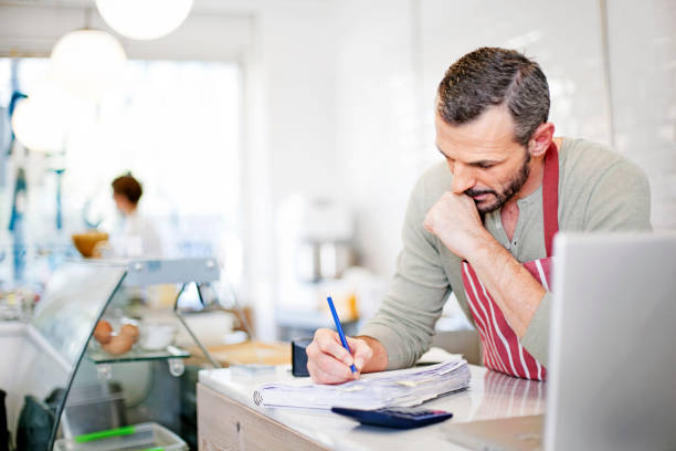 Business owner calculating stock photo