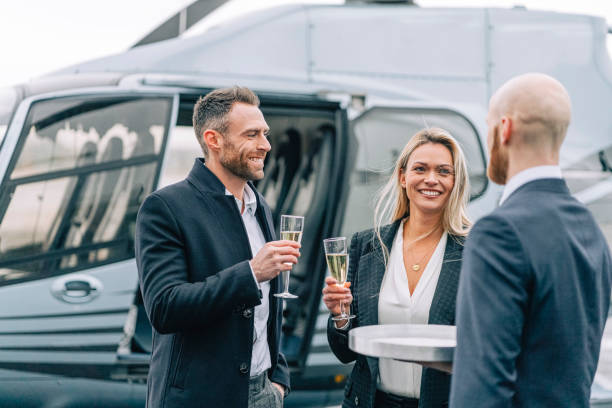 Business partners enjoying welcome drinks at the helipad stock photo