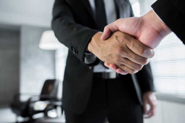 A business partnership handshake stock photo