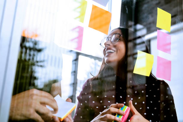 Business people brainstorming ideas with sticky notes stock photo