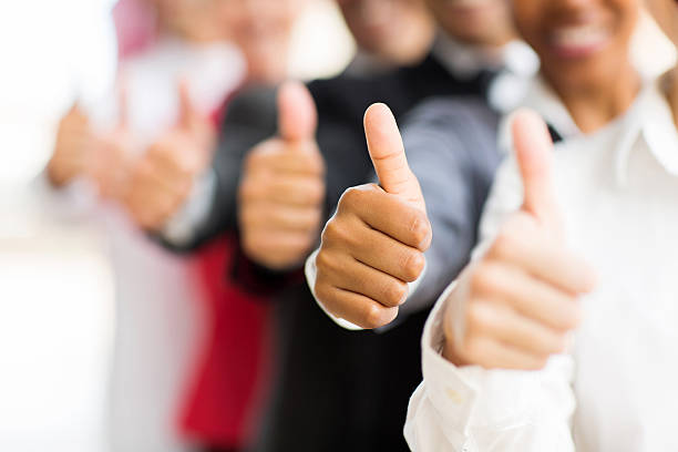 business people giving thumbs up closeup portrait of business people giving thumbs up business thumbs up stock pictures, royalty-free photos & images