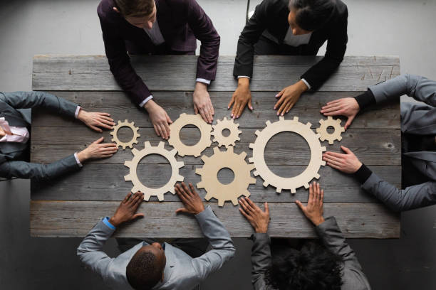 Business people joining together gears stock photo