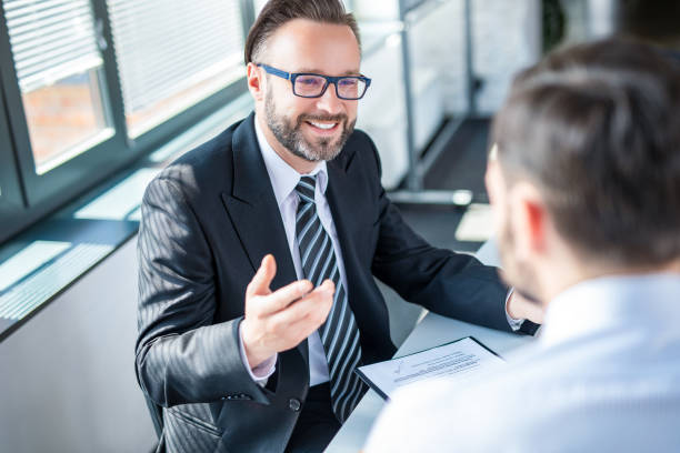 Business people negotiating a contract. Business people negotiating a contract. Human hands working with documents at desk and signing contract. financial advisor stock pictures, royalty-free photos & images