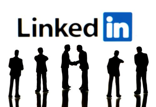 İstanbul, Turkey - April 5, 2014: Business figurines standing in front of Apple iPad monitor displaying LinkedIn logo. LinkedIn is a social networking service for people in professional occupations.
