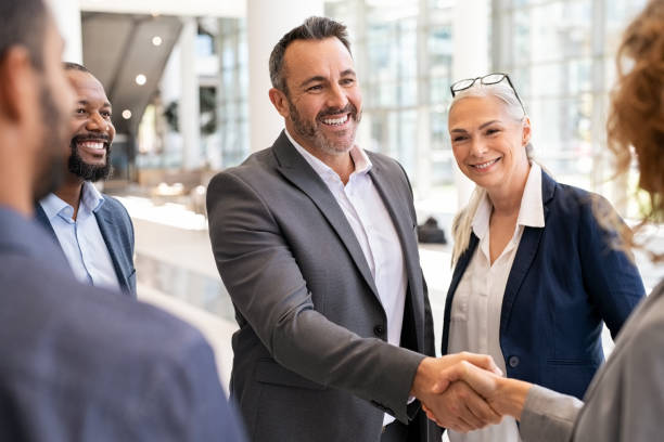 Business people shaking hands in meeting stock photo