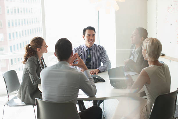 business people talking in meeting - japanse etniciteit stockfoto's en -beelden