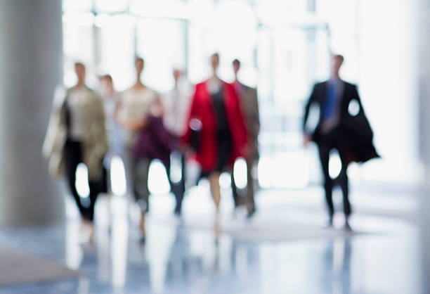 Business people walking in lobby  arrival stock pictures, royalty-free photos & images