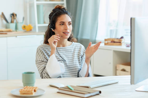 Business Person At Home Modern businesswoman spending morning at home talking with her colleagues using video conference app hands free device stock pictures, royalty-free photos & images