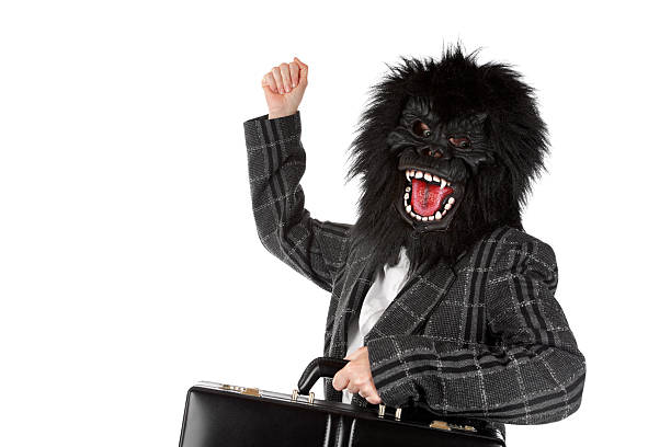 Business Success Enthusiastic businesswoman wearing a gorilla mask. laughing monkey stock pictures, royalty-free photos & images
