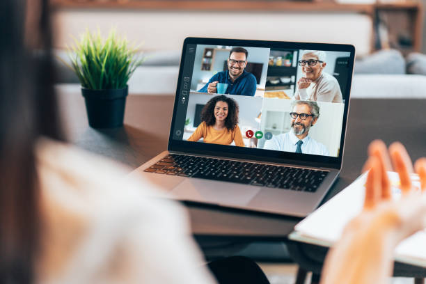 Business team in video conference Modern Multiethnic business team having discussion and online meeting in video call hot desking stock pictures, royalty-free photos & images
