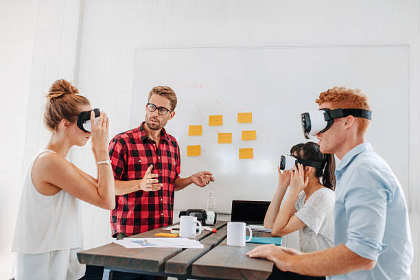 business team testing virtual reality headset in meeting - vr meeting stockfoto's en -beelden