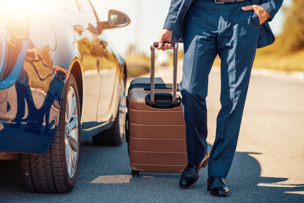 Business trip Traveling businessman with his luggage near car. luxury car stock pictures, royalty-free photos & images