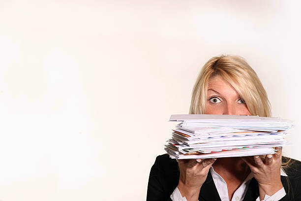 Business woman hold stack of Junk Mail and unpaid bills "A shocking expression as this business woman is overwhelmed by Junk Mail,Unpaid Bill,Collections, and solicitation offers on white background.  Lots of Copy Space!" direct mail marketing stock pictures, royalty-free photos & images