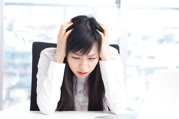 business woman holding her head stock photo