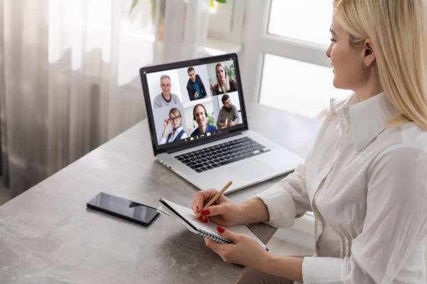 business woman talking to her colleagues about plan in video conference. business team using laptop for a online meeting in video call. Group of people smart working from home stock photo