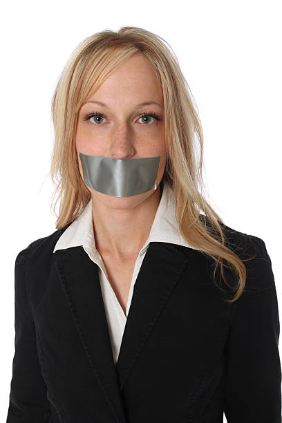 Business woman with duct tape over her mouth Business woman with duct tape over her mouthhttp://www.twodozendesign.info/i/1.png human mouth gag adhesive tape women stock pictures, royalty-free photos & images