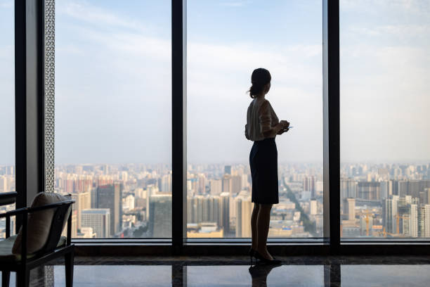 Business women in front of glass windows stock photo