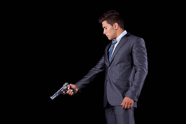 Businessman aiming a handgun stock photo