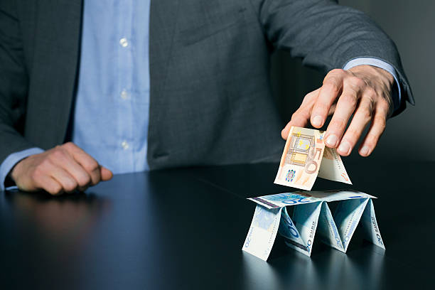 businessman building financial pyramid from euro money businessman building financial pyramid from euro paper money conspiracy stock pictures, royalty-free photos & images