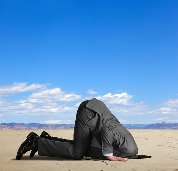 businessman-burying-his-head-in-the-sand