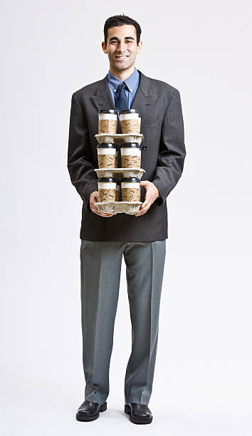 Businessman Carrying Stack of Coffee Cups stock photo