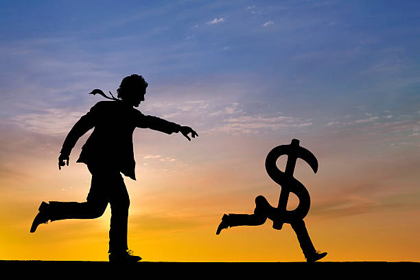 Businessman chasing money  escaping photos stock pictures, royalty-free photos & images