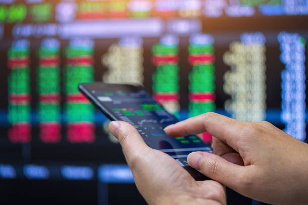 Businessman checking stock market on mobile phone,Stock market stock photo