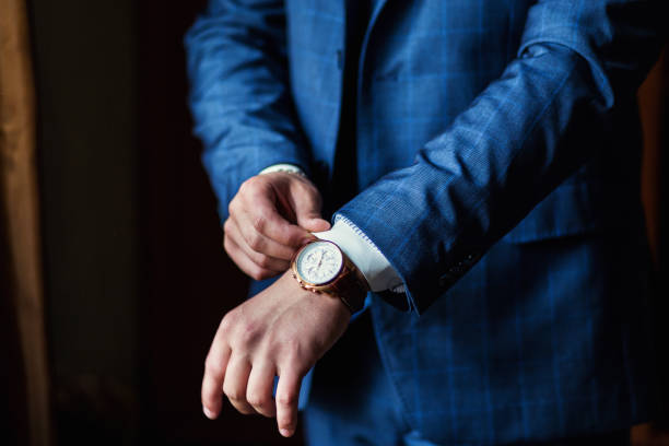 businessman clock clothes, businessman checking time on his wristwatch. men's hand with a watch, watch on a man's hand, the fees of the groom, wedding preparation, preparation for work, putting the clock on the hand, fasten clock watch time, man's style, stock photo