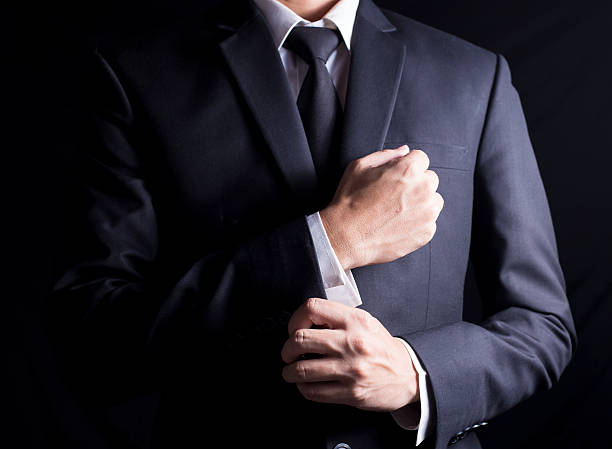 Businessman Fixing Cufflinks his Suit stock photo