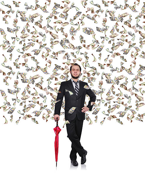 businessman flying dollar bills stock photo