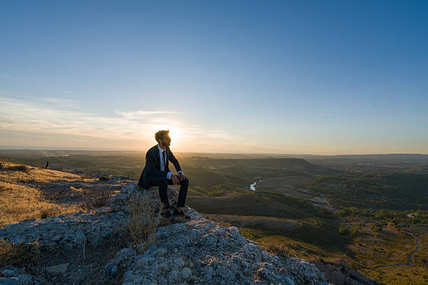 Photo of businessman freedom on the top of a high mountain