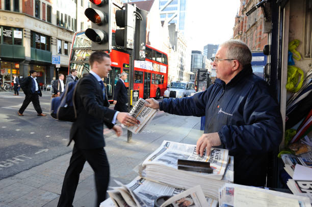 Businessman gets a free newspaper in London stock photo
