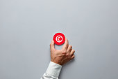 istock Businessman hand holding a red badge with copyright symbol. Property rights and brand patent protection in business 1301175061