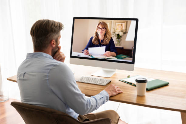 Businessman having video conference while working at home office stock photo