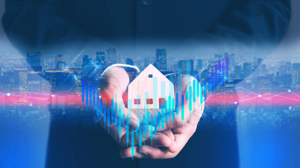 Businessman holding house model with city hologram show financial stock market increase profit cyber punk theme color stock photo