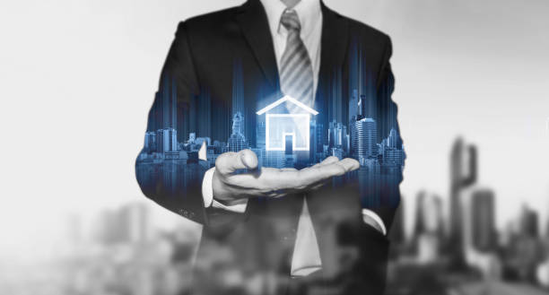 Businessman holding modern buildings hologram, and home icon. Real estate business, building technology and smart home concept Businessman holding modern buildings hologram, and home icon. Real estate business, building technology and smart home concept real estate stock pictures, royalty-free photos & images